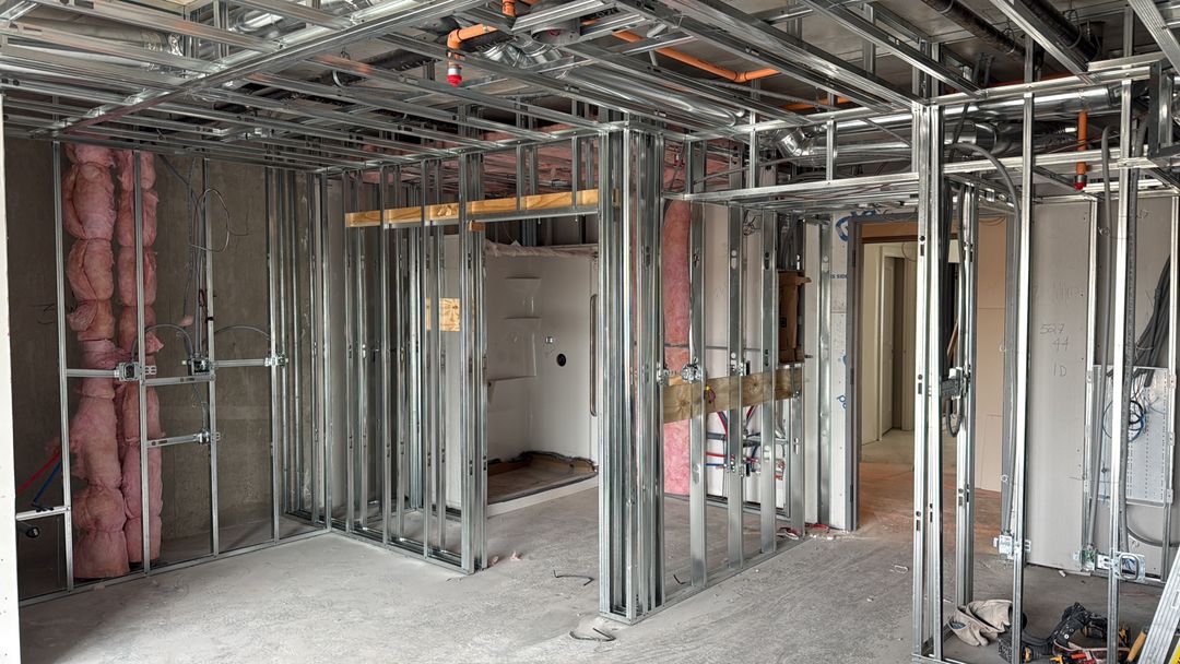 Metal framing and insulation installation at an Arca Construction project